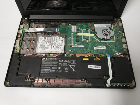 Remove the keyboard panel completely and set it aside. The internal components of the laptop are now exposed.